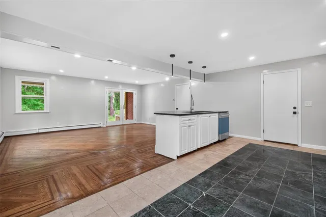 a view of a kitchen with a sink stainless steel appliances and cabinets