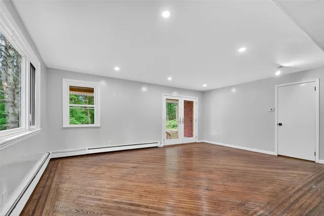 wooden floor in an empty room with a window