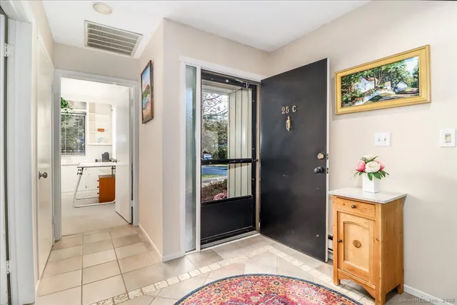 a view of a hallway view with wooden floor and living room