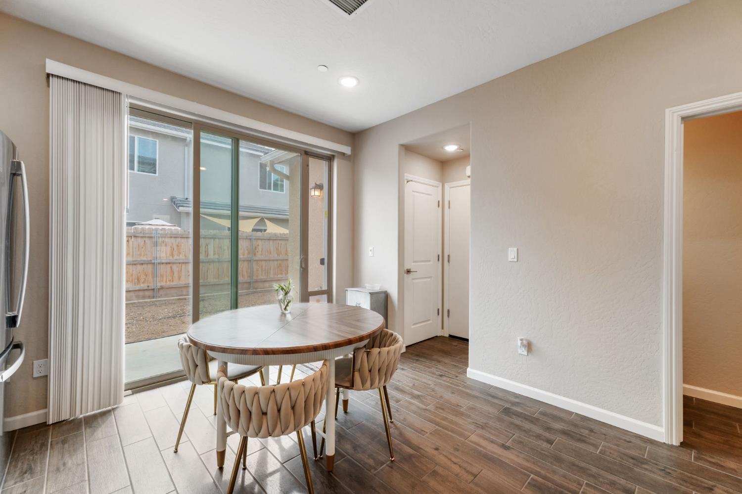 1106 Significant Way West Madera, CA 93636 - Photo 14 of 41 a view of a dining room with furniture window and wooden floor
