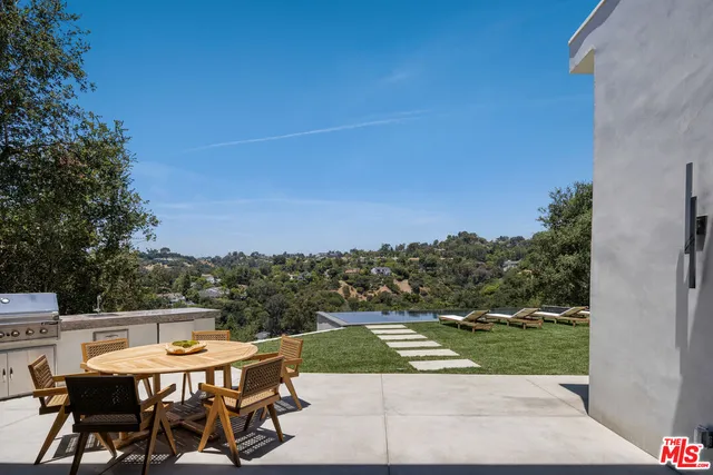 a view of a balcony with a table and chairs
