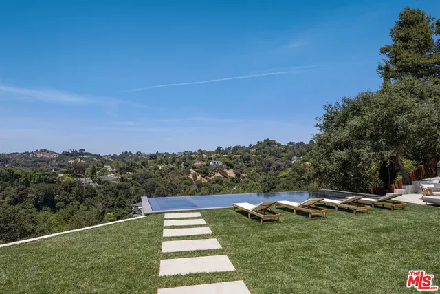 a view of a backyard with sitting area