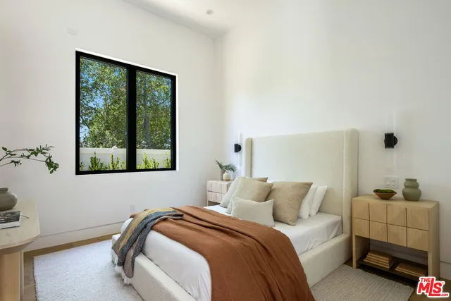 a bathroom with a double vanity sink a mirror and a bathtub