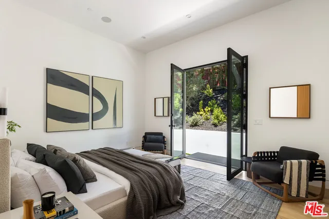 a bedroom with a bed and a couch