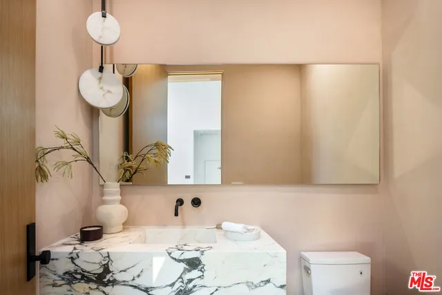 a bathroom with a sink vanity and mirror