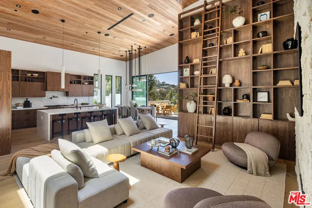 a living room with furniture and a floor to ceiling window