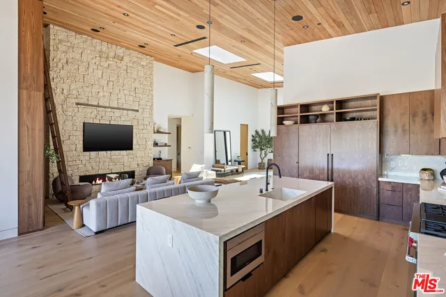 a kitchen with sink refrigerator and microwave