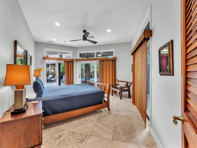 a bedroom with furniture and a flat screen tv