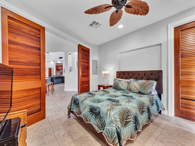 a bedroom with a bed and ceiling fan