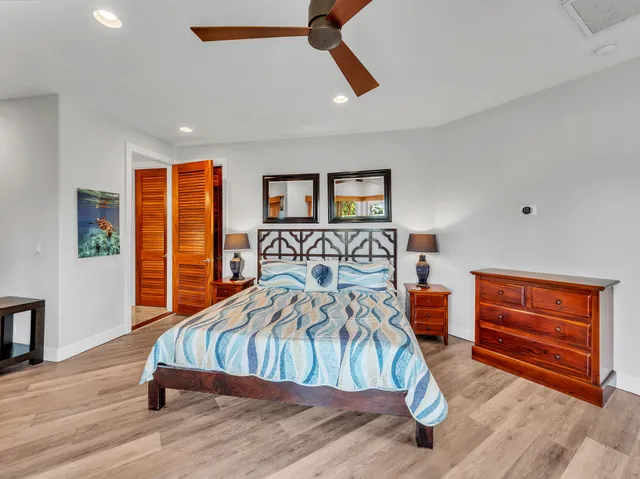 a bedroom with furniture and a wooden floor