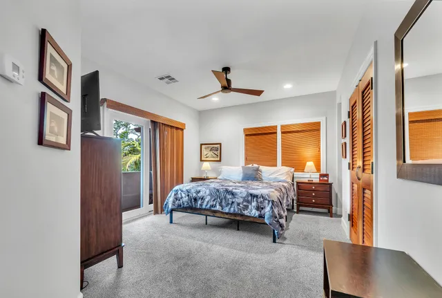 a bedroom with a bed couch and window