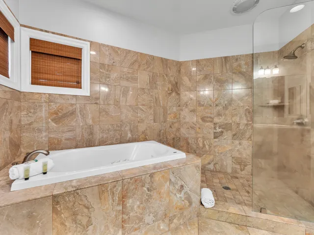 a bathroom with a bathtub and shower