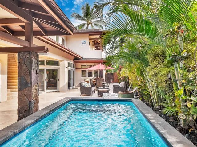 a view of a porch with chairs and potted plants