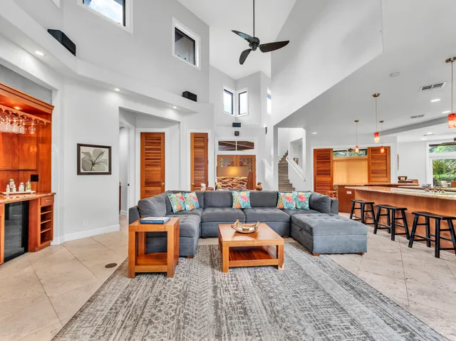 a living room with furniture a table and a large window