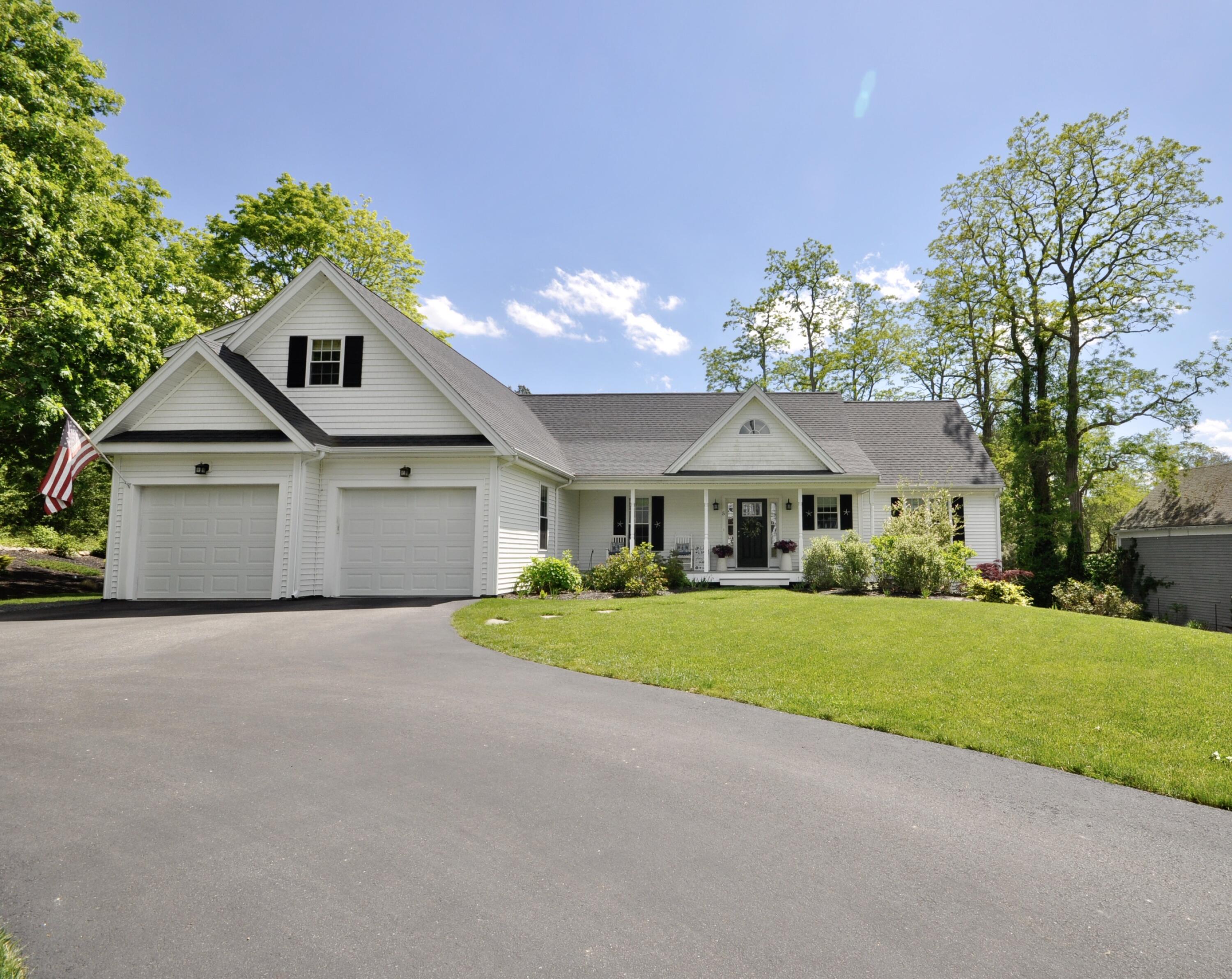 5 Bournedale Road Buzzards Bay, MA 02532 - Photo 1 of 39 a front view of a house with a yard and garage