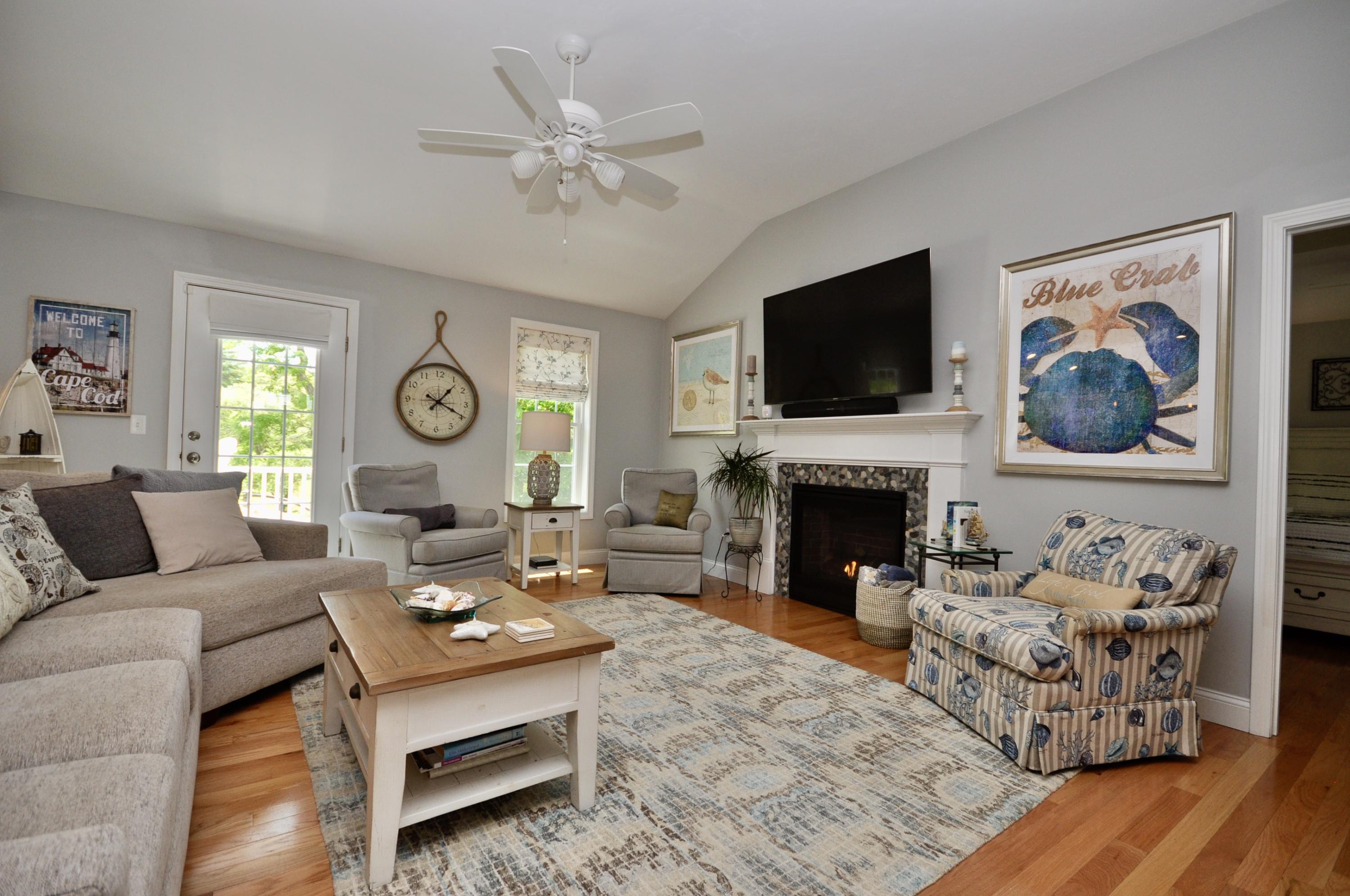 5 Bournedale Road Buzzards Bay, MA 02532 - Photo 17 of 39 a living room with furniture a fireplace and a flat screen tv
