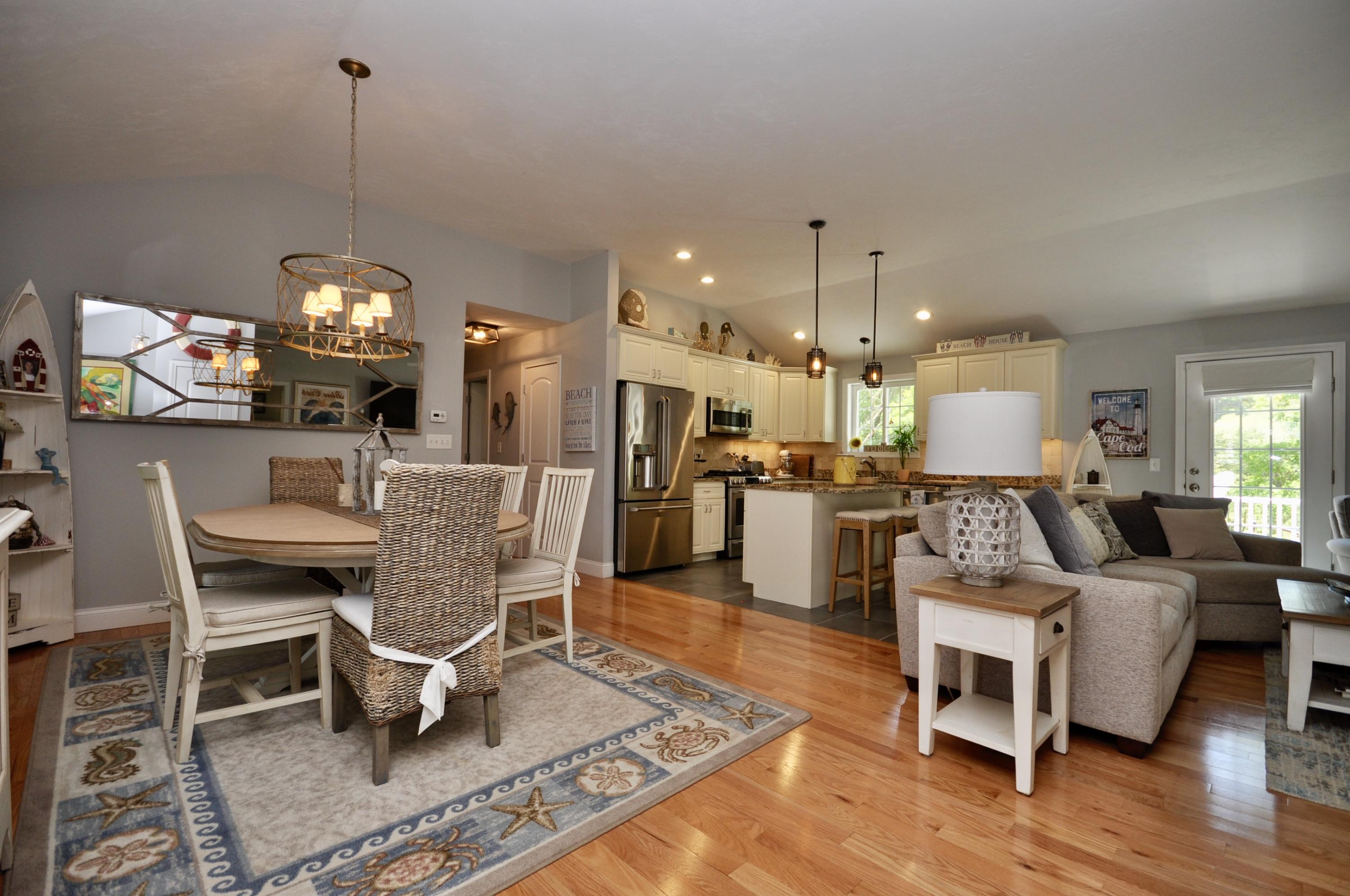 5 Bournedale Road Buzzards Bay, MA 02532 - Photo 18 of 39 a living room with furniture a dining table and a chandelier