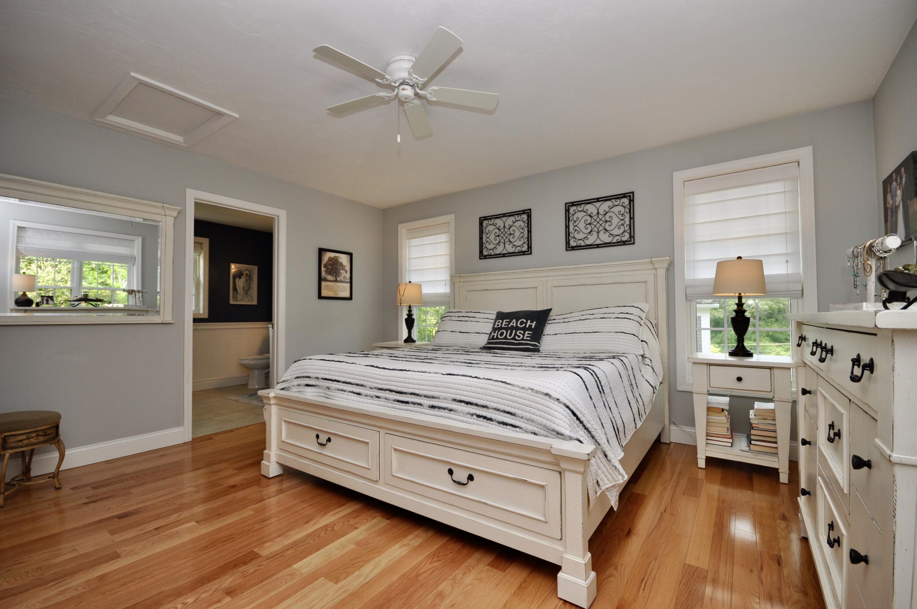 5 Bournedale Road Buzzards Bay, MA 02532 - Photo 19 of 39 a spacious bedroom with a bed and a chandelier