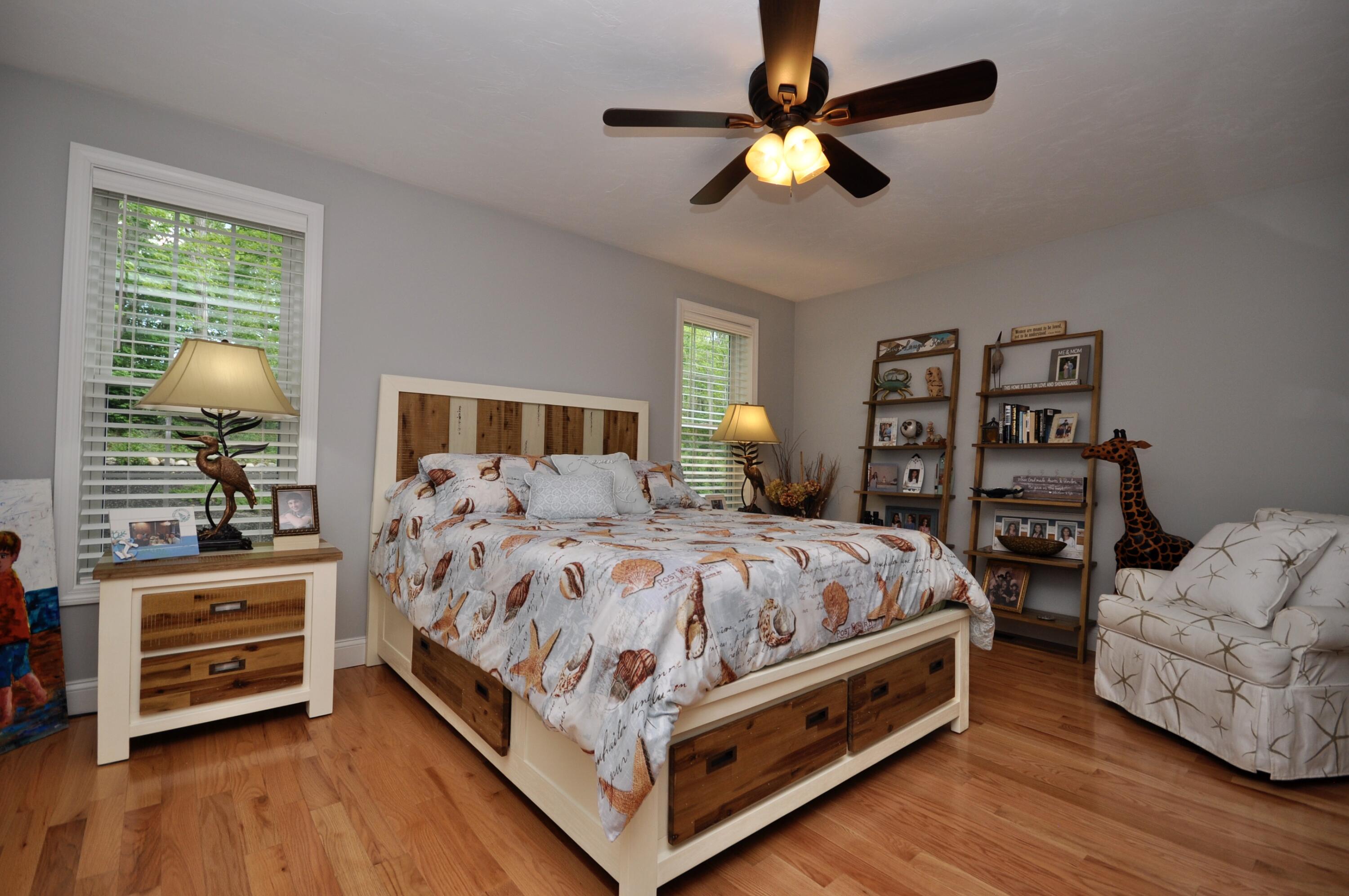 5 Bournedale Road Buzzards Bay, MA 02532 - Photo 23 of 39 a bed sitting in a bedroom next to a window with a large bed and a chandelier