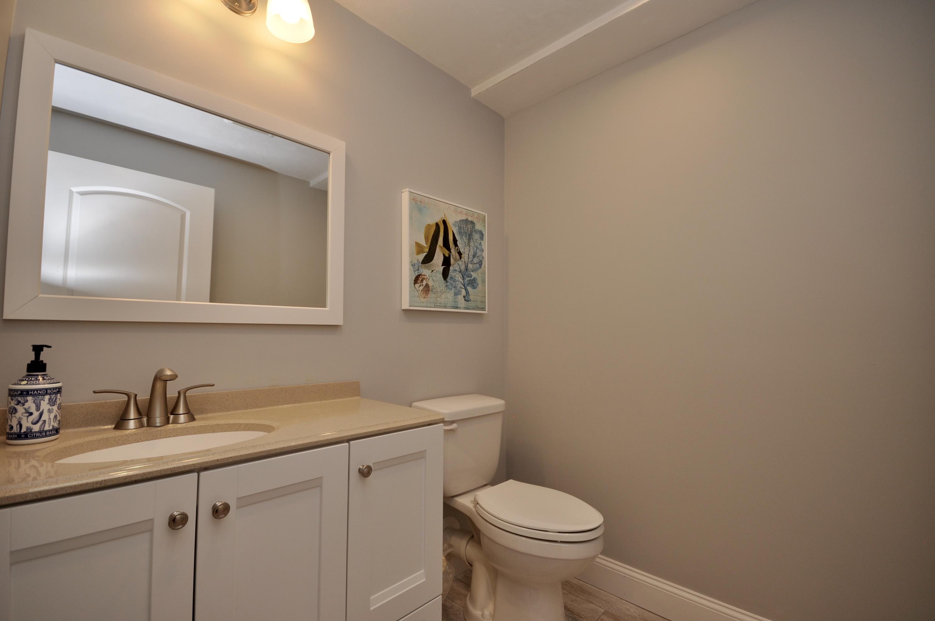 5 Bournedale Road Buzzards Bay, MA 02532 - Photo 32 of 39 a bathroom with a toilet sink and mirror