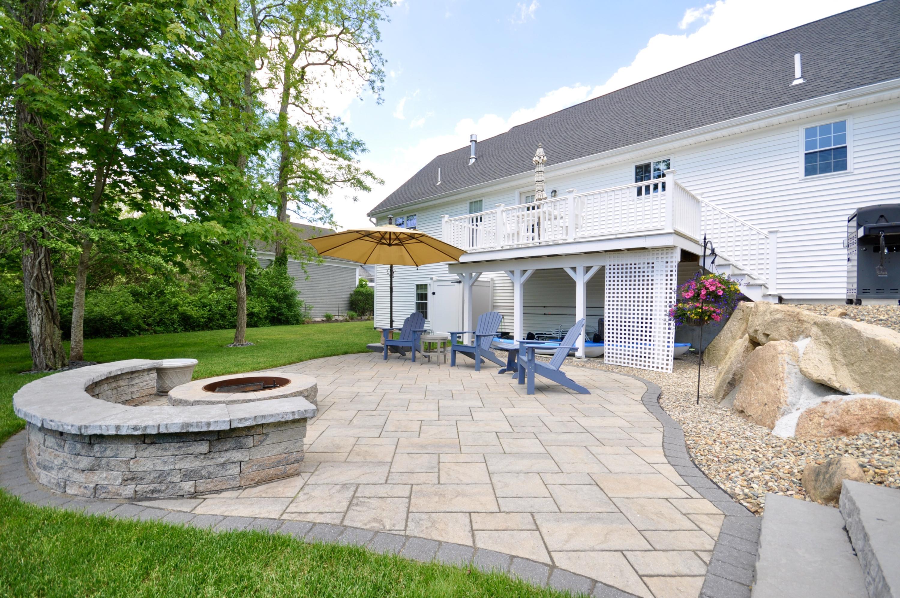 5 Bournedale Road Buzzards Bay, MA 02532 - Photo 34 of 39 a view of a patio with a table and chairs under an umbrella