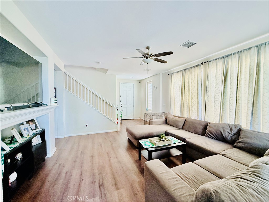 1652 Apollo Way Beaumont, CA 92223 - Photo 11 of 25 a living room with furniture and a flat screen tv