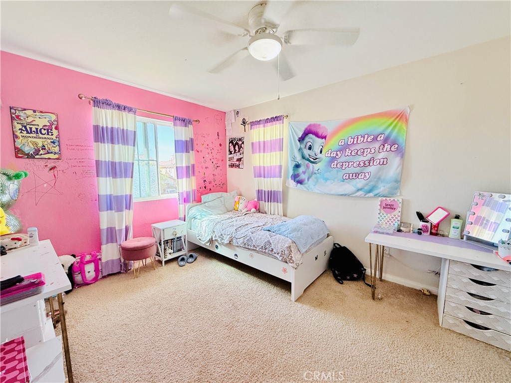 1652 Apollo Way Beaumont, CA 92223 - Photo 15 of 25 a bedroom with a bed and a window
