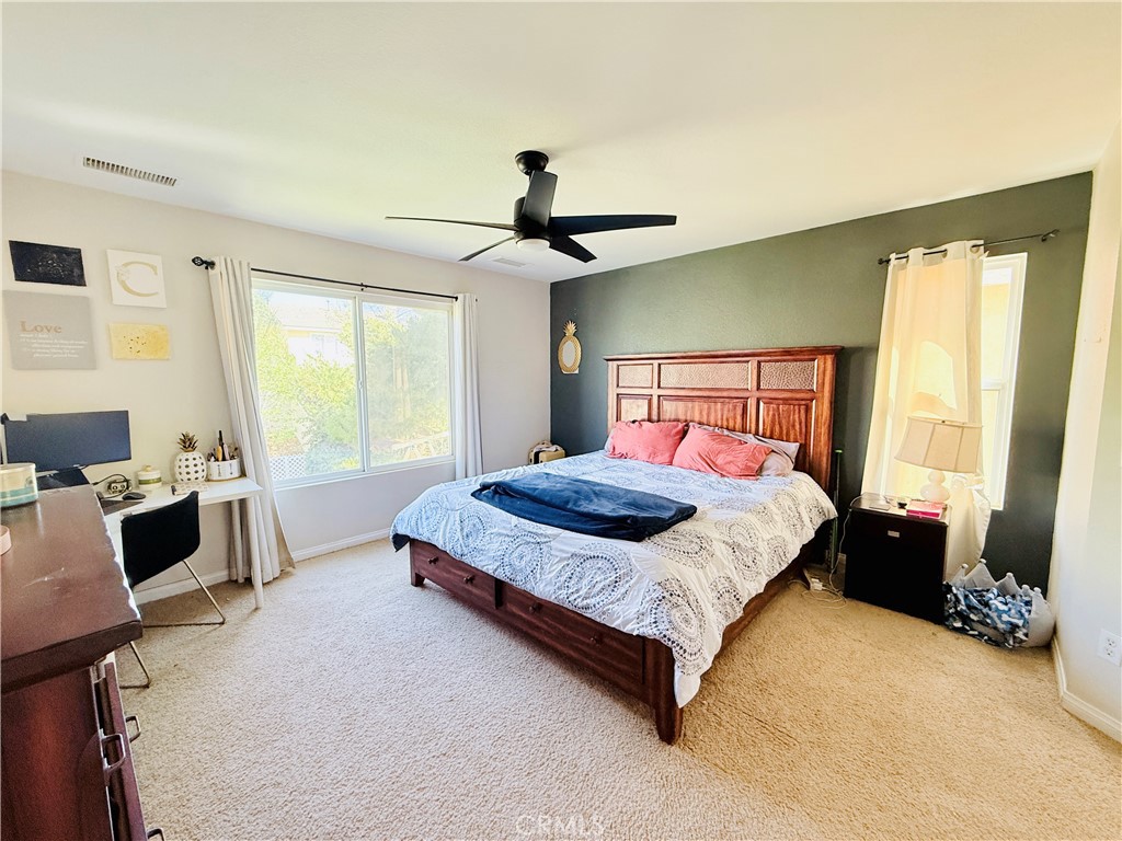 1652 Apollo Way Beaumont, CA 92223 - Photo 7 of 25 a bedroom with a bed and a desk