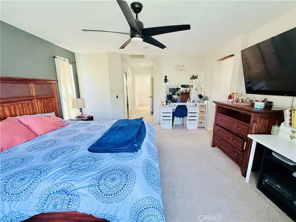 a bed room with furniture and a flat screen tv