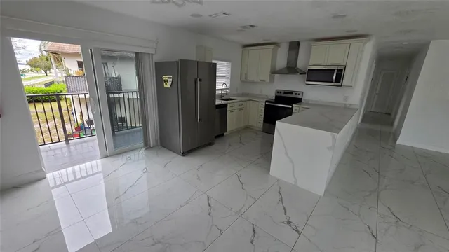 a kitchen with stainless steel appliances a refrigerator and a stove top oven