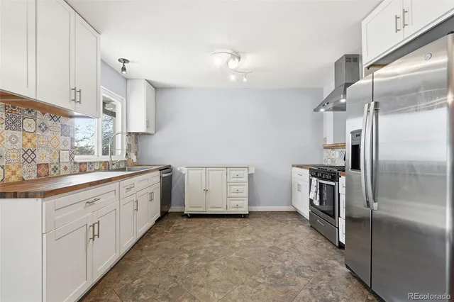 a kitchen with cabinets and stainless steel appliances