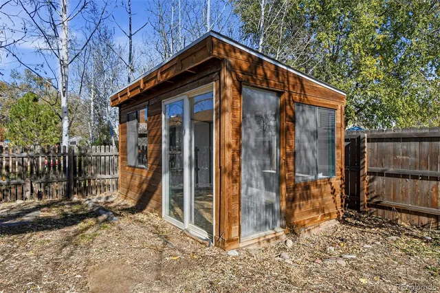 a view of a house with wooden fence