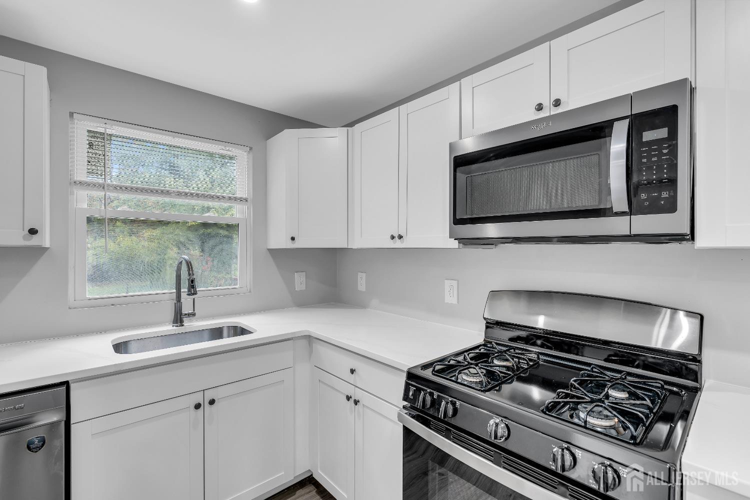 52 MacArthur Drive Edison, NJ 08837 - Photo 14 of 37 a kitchen with stainless steel appliances a sink a stove and cabinets