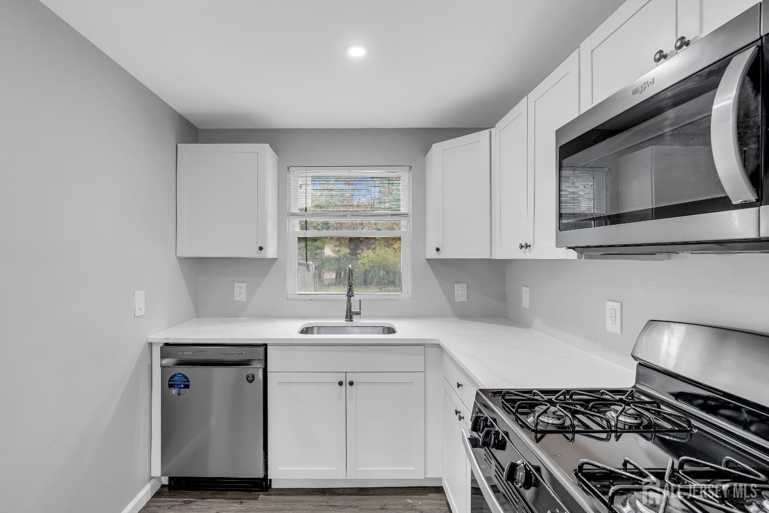 52 MacArthur Drive Edison, NJ 08837 - Photo 16 of 37 a kitchen with stainless steel appliances a white stove top oven and sink