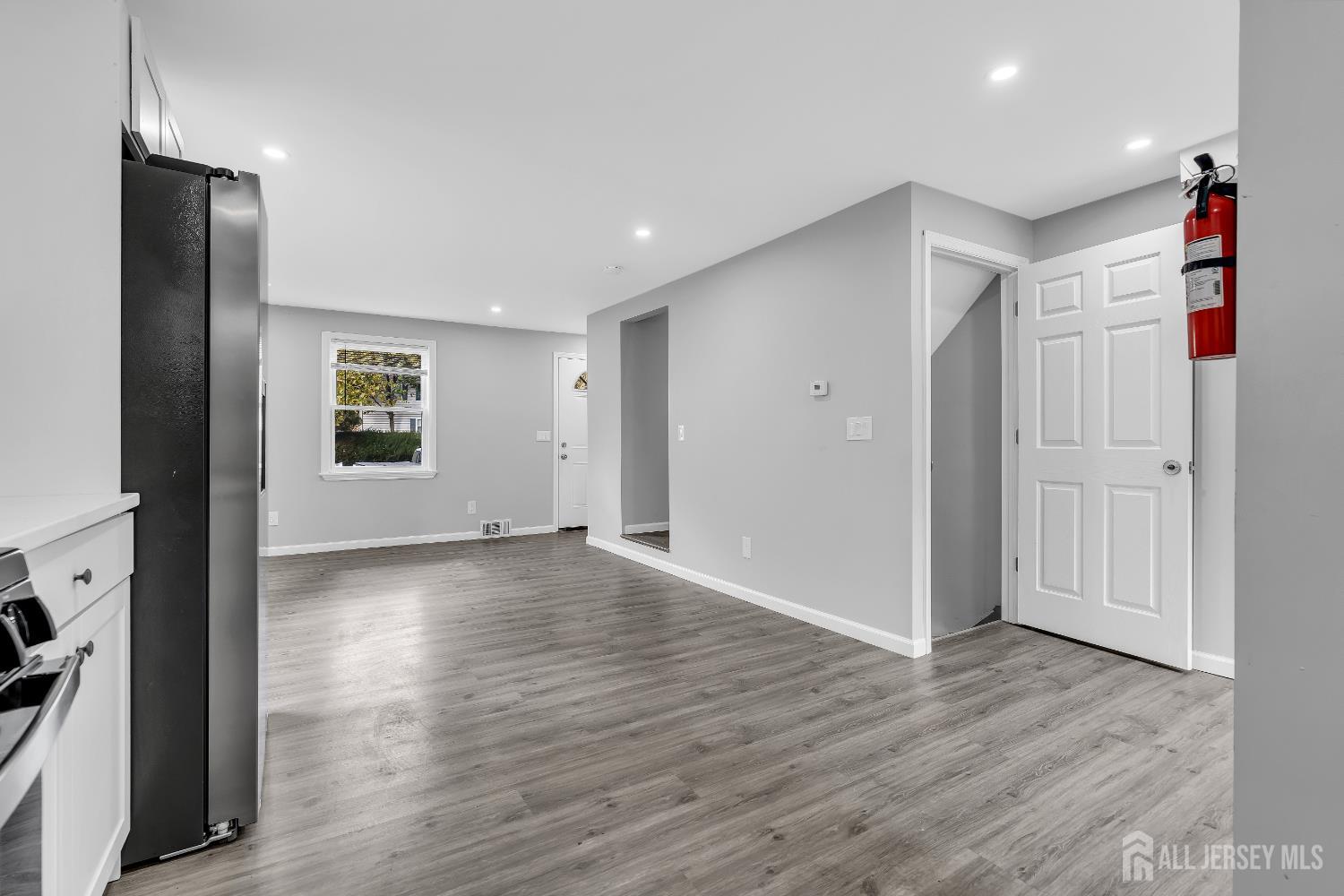 52 MacArthur Drive Edison, NJ 08837 - Photo 17 of 37 an empty room with wooden floor and windows