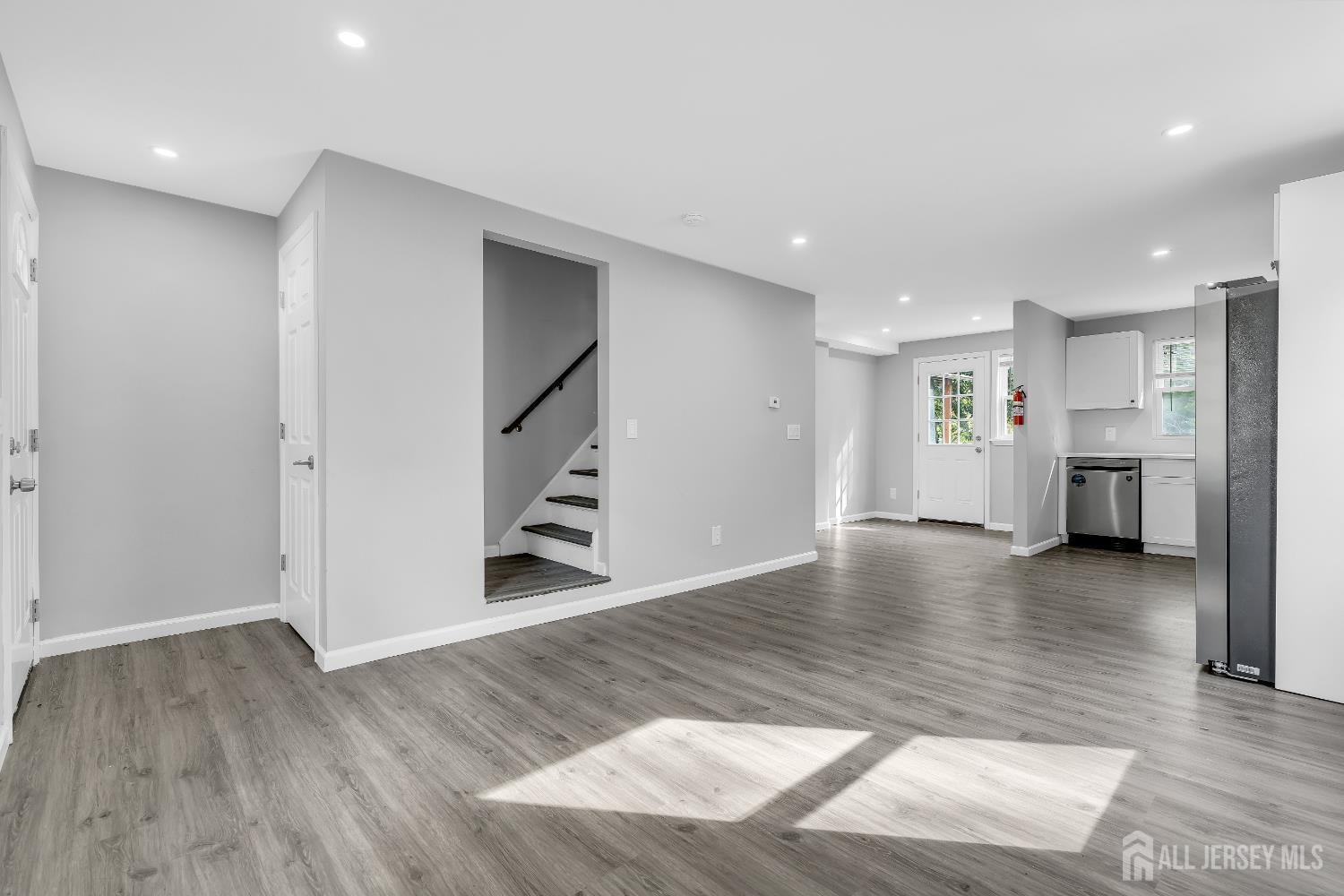 52 MacArthur Drive Edison, NJ 08837 - Photo 19 of 37 a view of empty room with kitchen and window