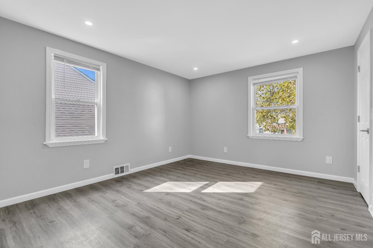 52 MacArthur Drive Edison, NJ 08837 - Photo 20 of 37 an empty room with wooden floor and windows