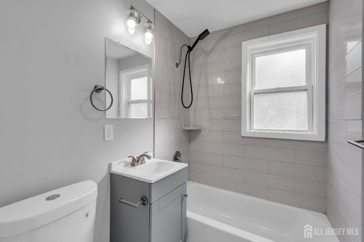 52 MacArthur Drive Edison, NJ 08837 - Photo 22 of 37 a bathroom with a granite countertop sink a toilet and a bathtub