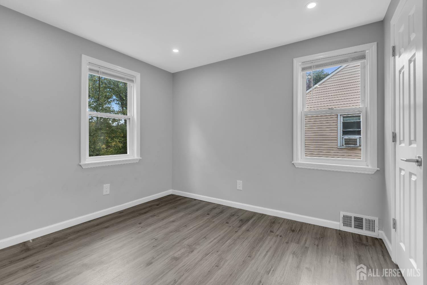 52 MacArthur Drive Edison, NJ 08837 - Photo 23 of 37 a view of a big room with wooden floor and windows