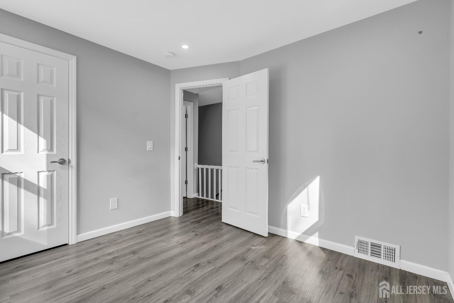 52 MacArthur Drive Edison, NJ 08837 - Photo 24 of 37 a view of an empty room with wooden floor and a window
