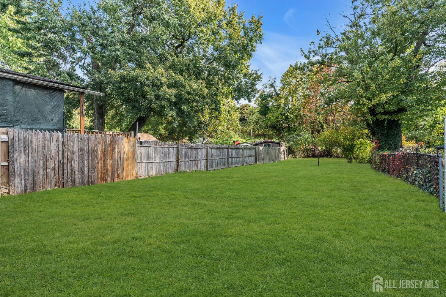 52 MacArthur Drive Edison, NJ 08837 - Photo 31 of 37 a view of a yard with a wooden fence