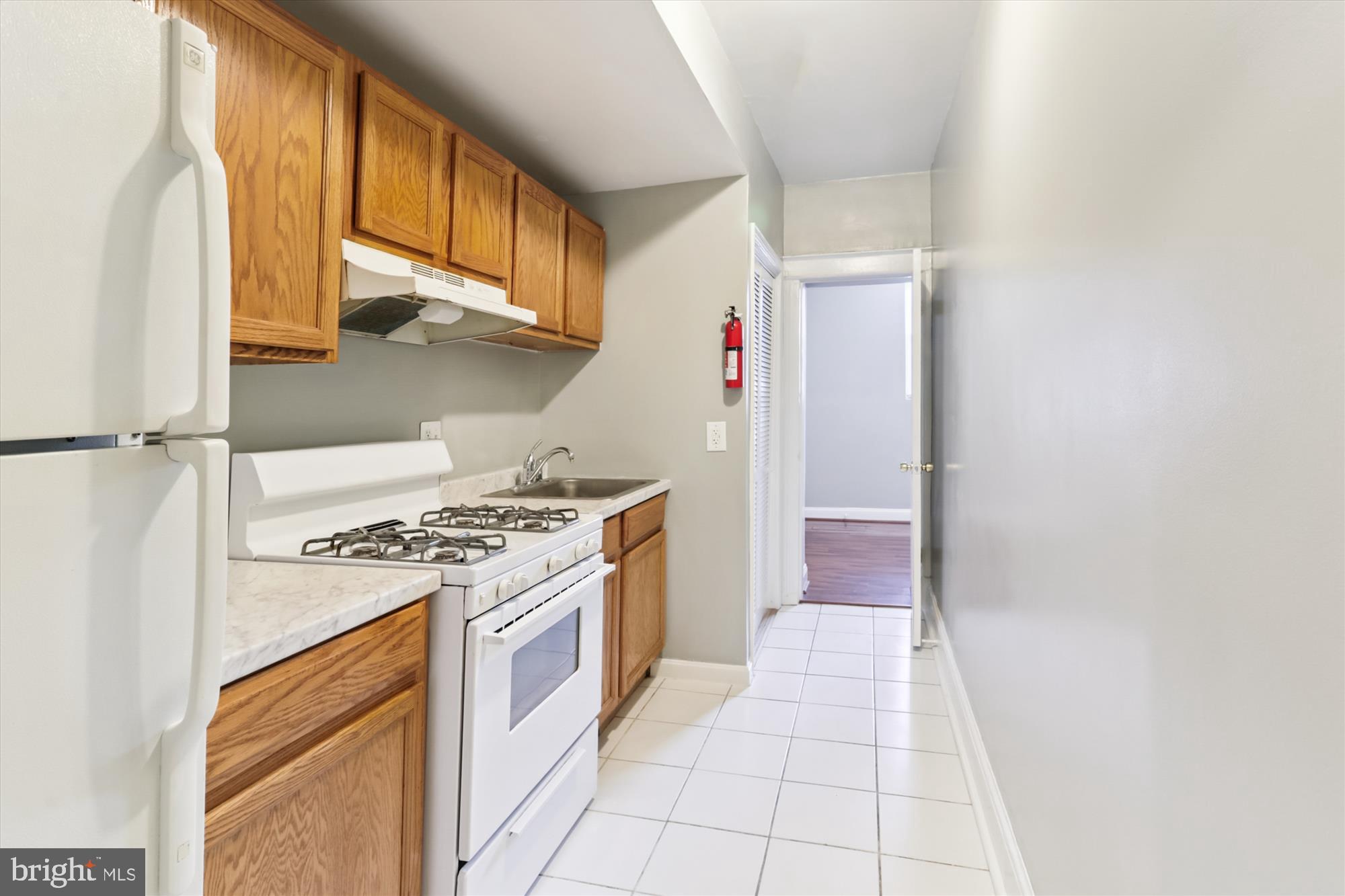1712 West Virginia Avenue Northeast, Unit 1 Washington, DC 20002 - Photo 5 of 15 a kitchen with a stove top oven and cabinets