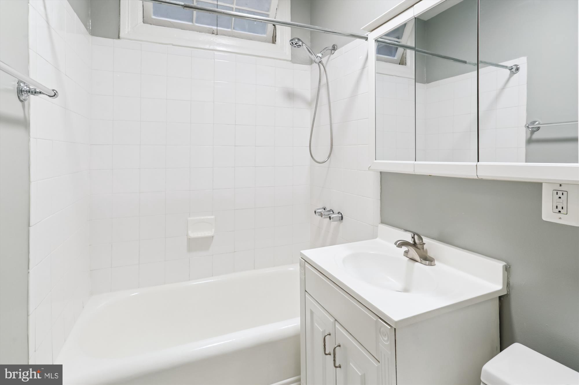 1712 West Virginia Avenue Northeast, Unit 1 Washington, DC 20002 - Photo 8 of 15 a bathroom with a sink a mirror and a bathtub