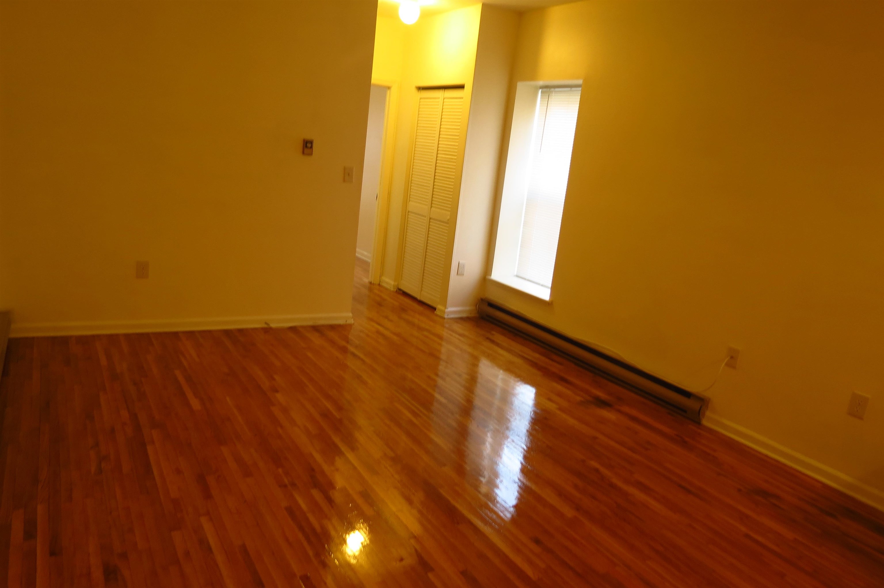533 Monroe Street, Unit 1D Hoboken, NJ 07030 - Photo 10 of 13 a view of a room with wooden floor and a window