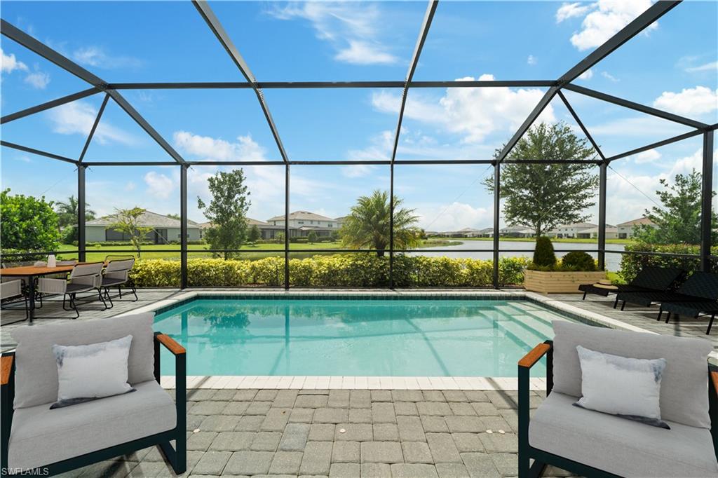 2385 Orchard Street Naples, FL 34120 - Photo 4 of 41 Virtually Staged screened in pool with lake view.