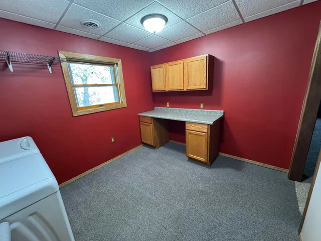 a view of backyard with large trees and a lawn chair