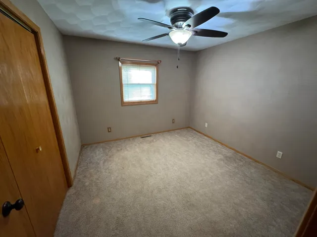 a room with stainless steel appliances wooden cabinets and a sink