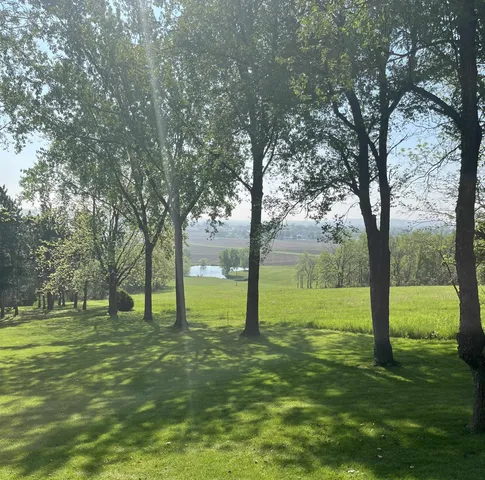 an open kitchen with wooden floor and windows