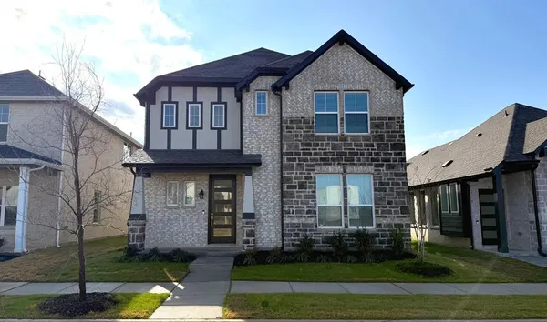 a view of a brick house with large windows