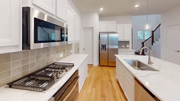 a kitchen with a sink and a stove top oven